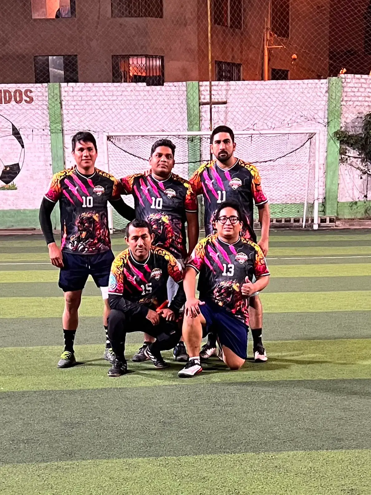 Amigos futbolistas posando en una cancha de Lima Norte